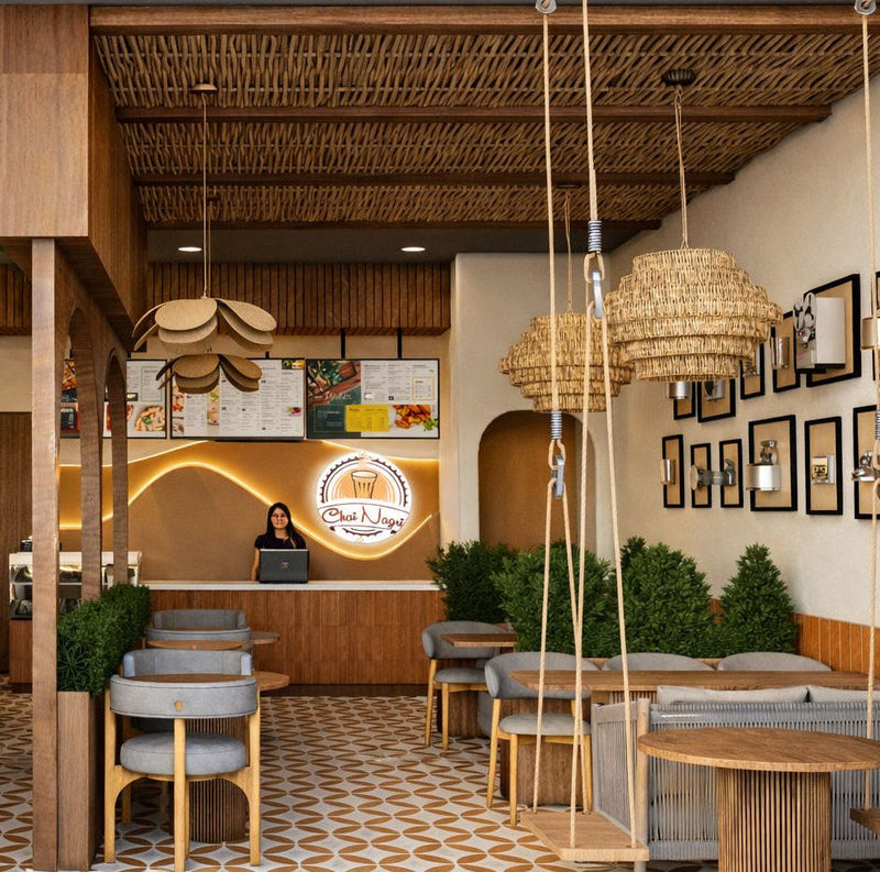 Modern restaurant interior with wooden tables, chairs, and decorative elements.